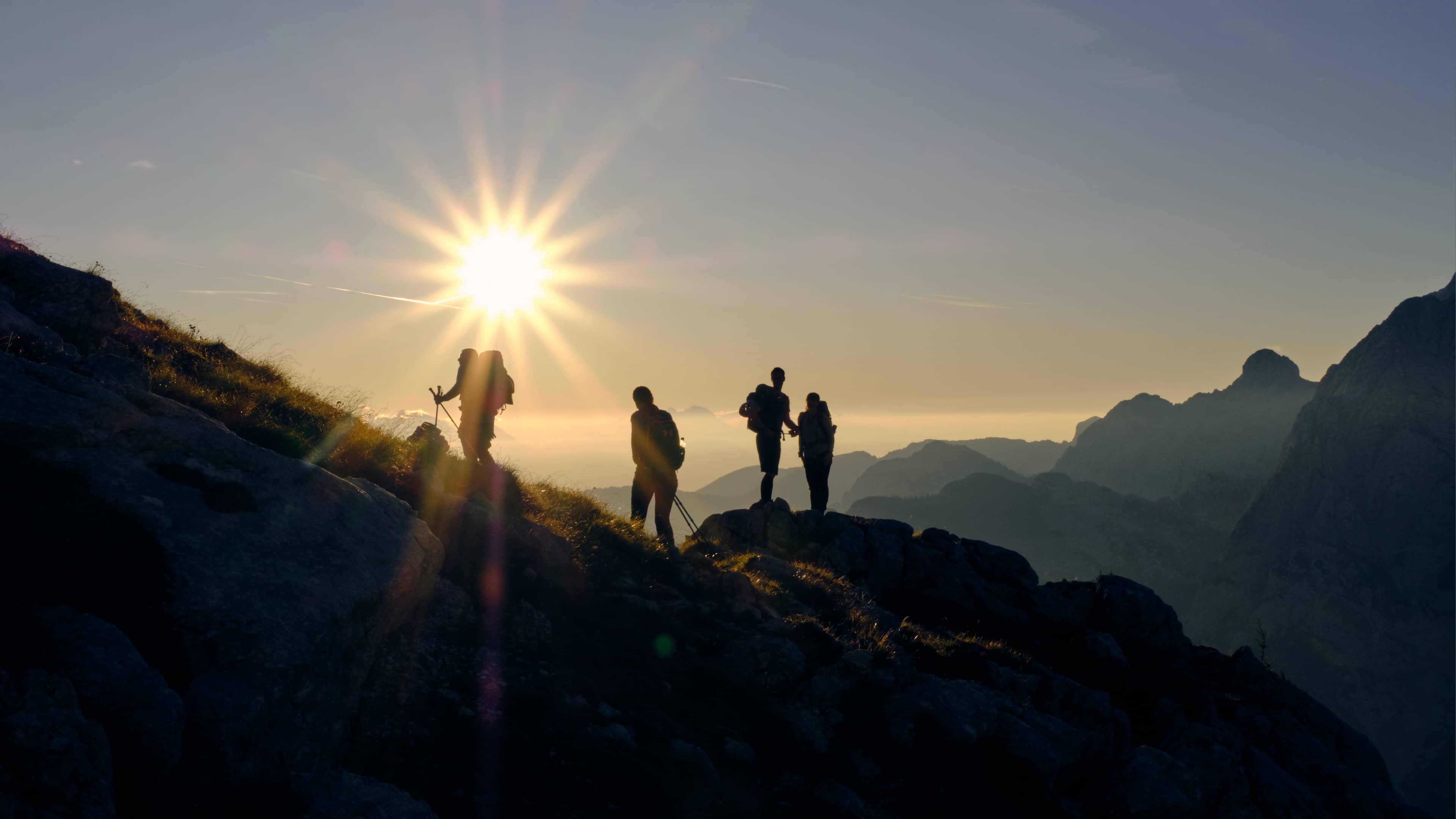 Section Background - four people hike on a mountain